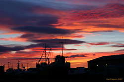 Sunset over a beached boat
