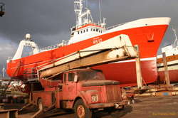 Big old truck, fresh paint on a big old boat
