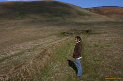 Alex standing near some ruins
