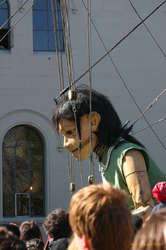 The giantess stoops down to talk to someone

