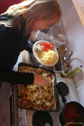 Chelle decorating pizza
