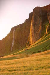 Waterfalls in the shade and the sun near Paradisahellir
