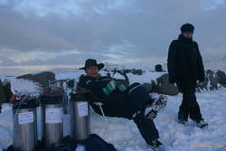 Toti pulls up a seat by the beer, Herdis watches
