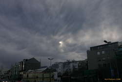 Clouds over the sun downtown
