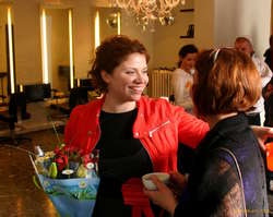 Björg G mingling at her opening
