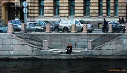 Two girls having a smoke on the riverbank

