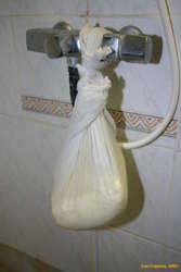 Hanging the curd to drain
