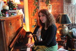 Kata testing the tune on the piano
