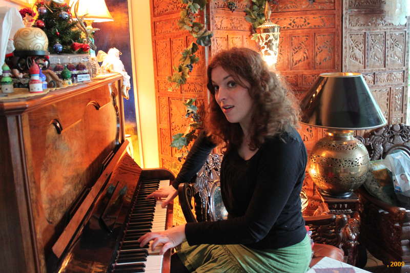 Kata testing the tune on the piano
